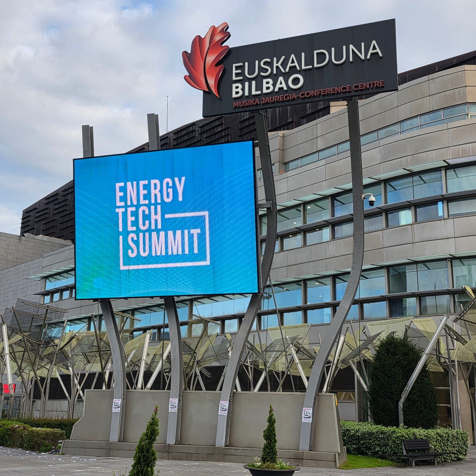 Exterior of the Euskalduna Conference Centre in Bilbao with a large Energy Tech Summit screen above the entrance