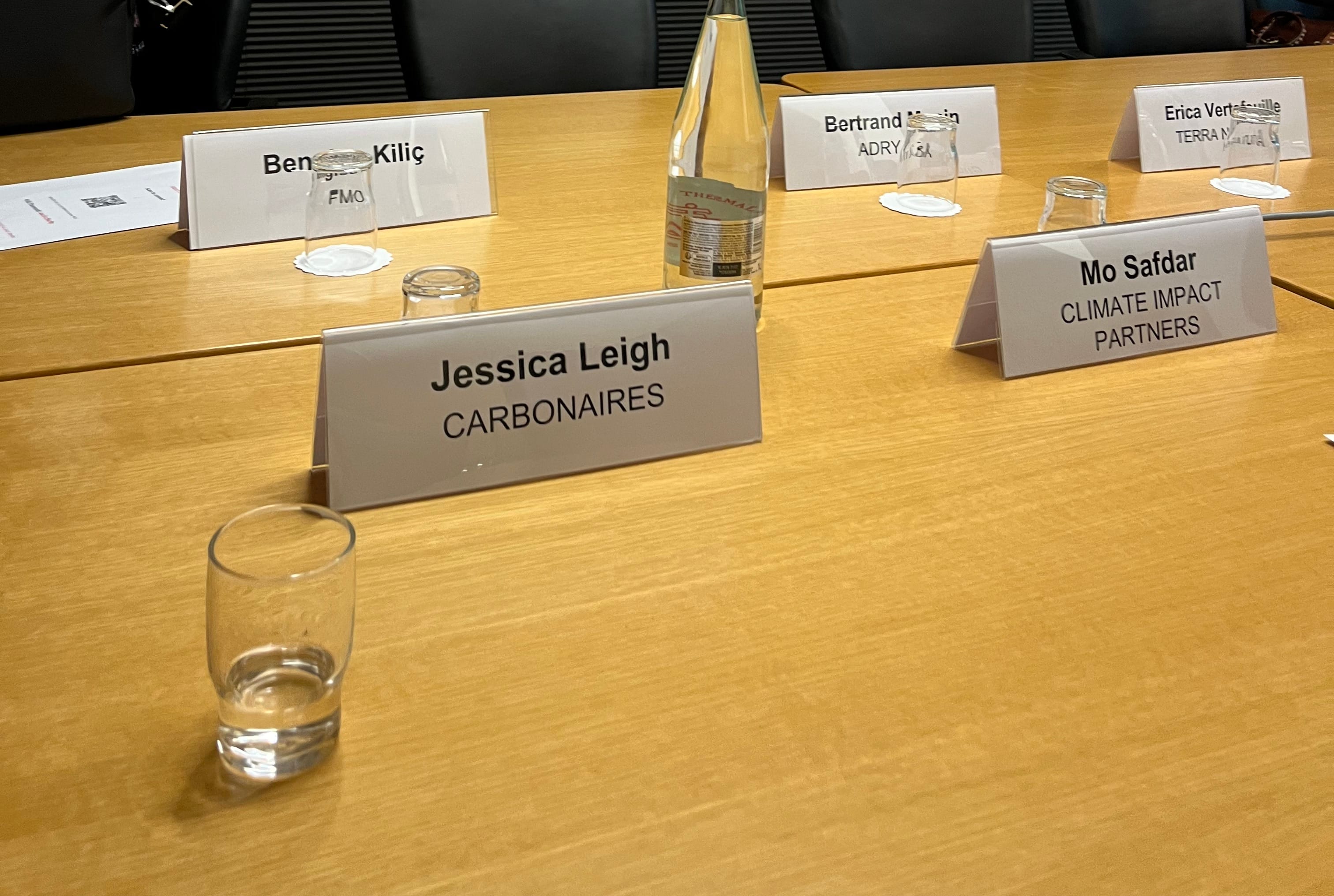 Conference table at the World Bank Group Nature-Smart Business Solutions Workshop in Paris, showing name placards for Jessica Leigh of Carbonaires, Mo Safdar of Climate Impact Partners, and Ben Kiliç of FMO