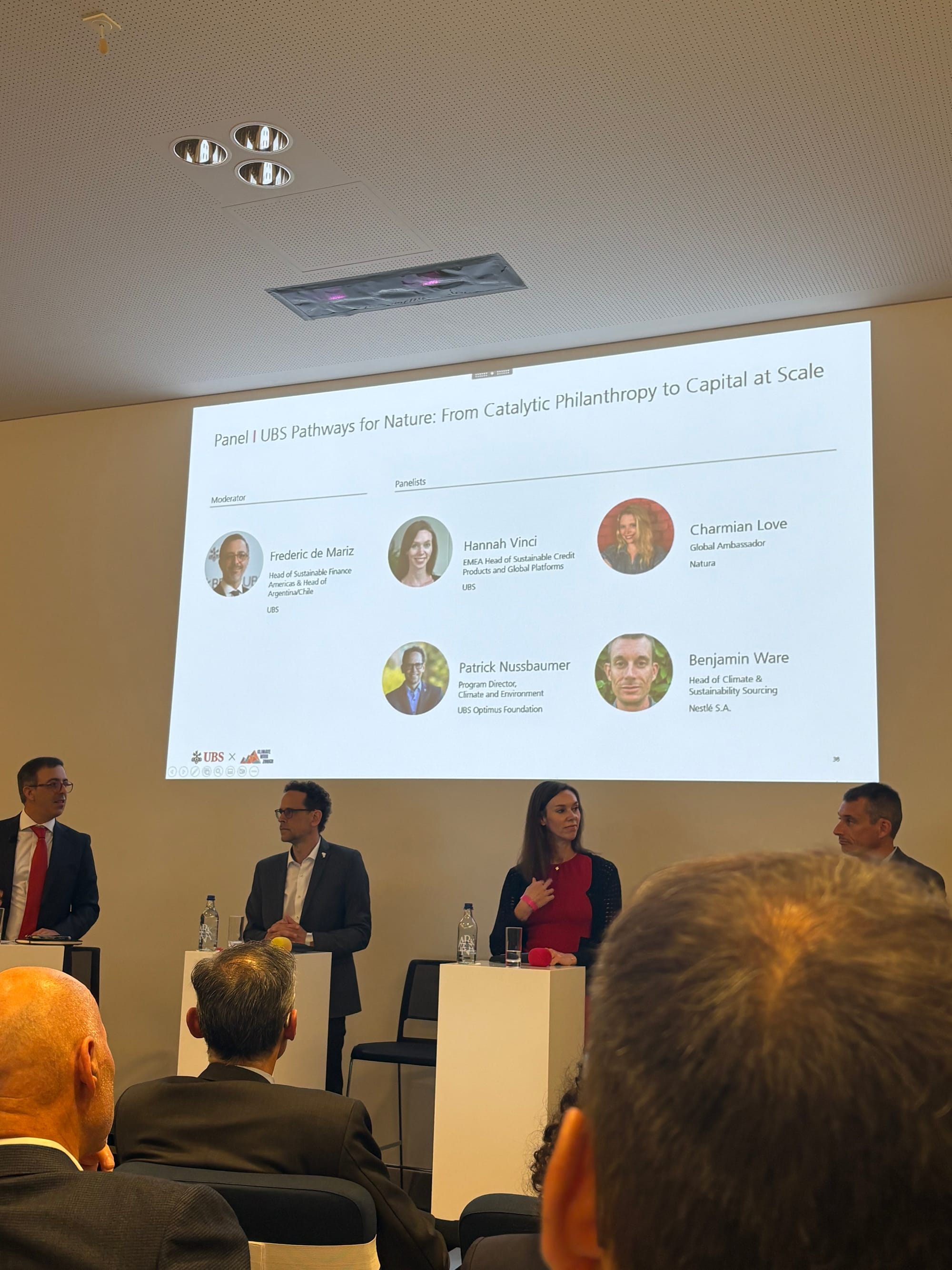 UBS conference slide titled "Panel I UBS Pathway for Nature: from Catalytic Philanthropy to Capital at Scale" showing four panellists, with the audience seated in front of the screen